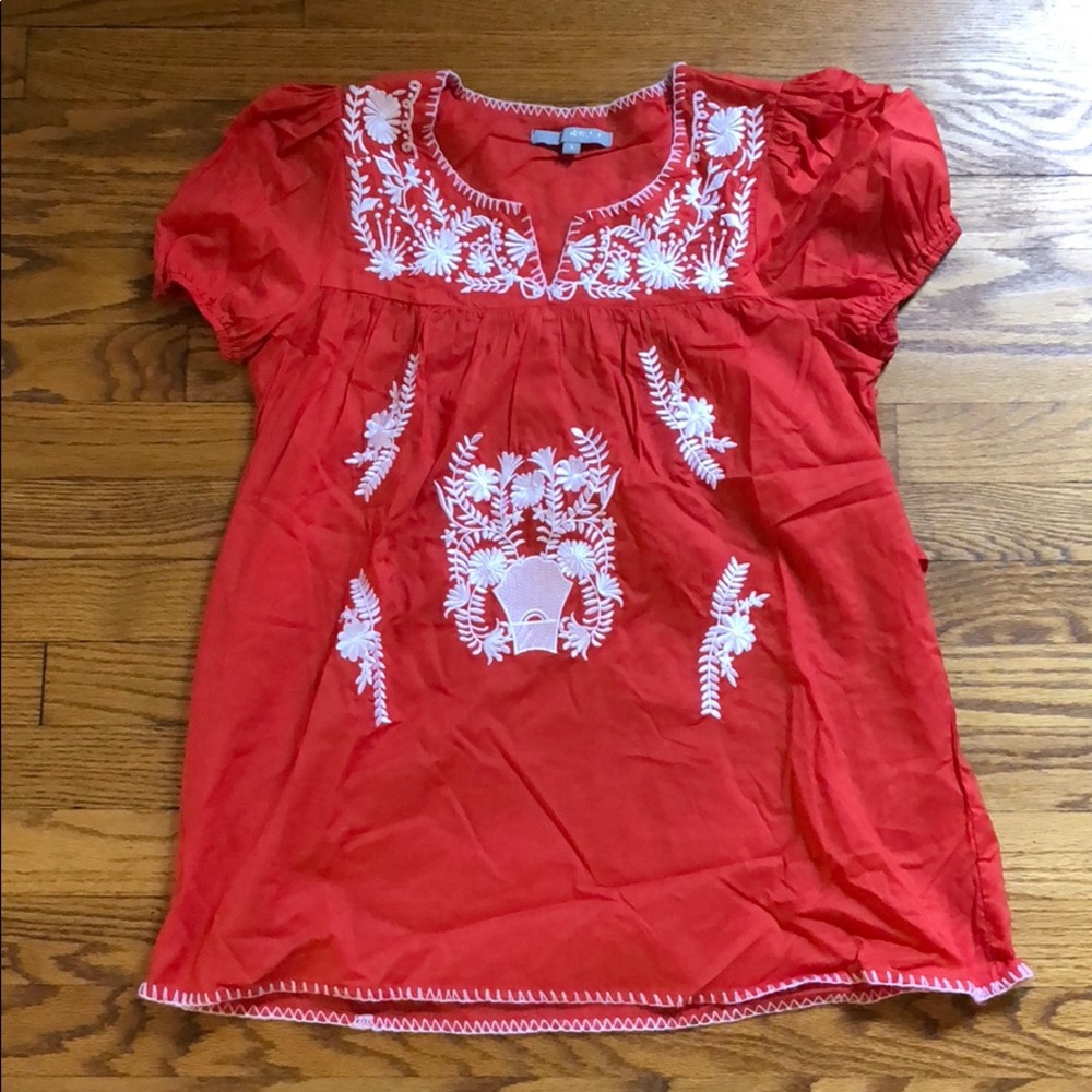 Orange blouse with white embroidery